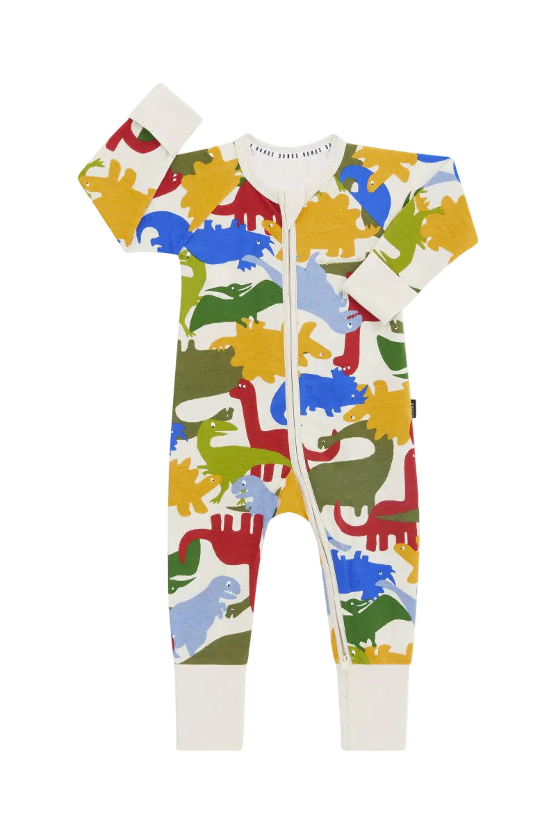Bonds Zip Wondersuit baby sleepsuit in Dino Dance Party white dinosaur print. Front view.