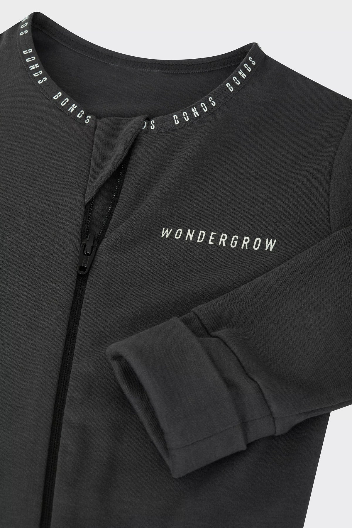 Bonds WonderGrow Zip Wondersuit bamboo baby sleepsuit in La Femme Nikita black. Close up of zip and rollable cuff.