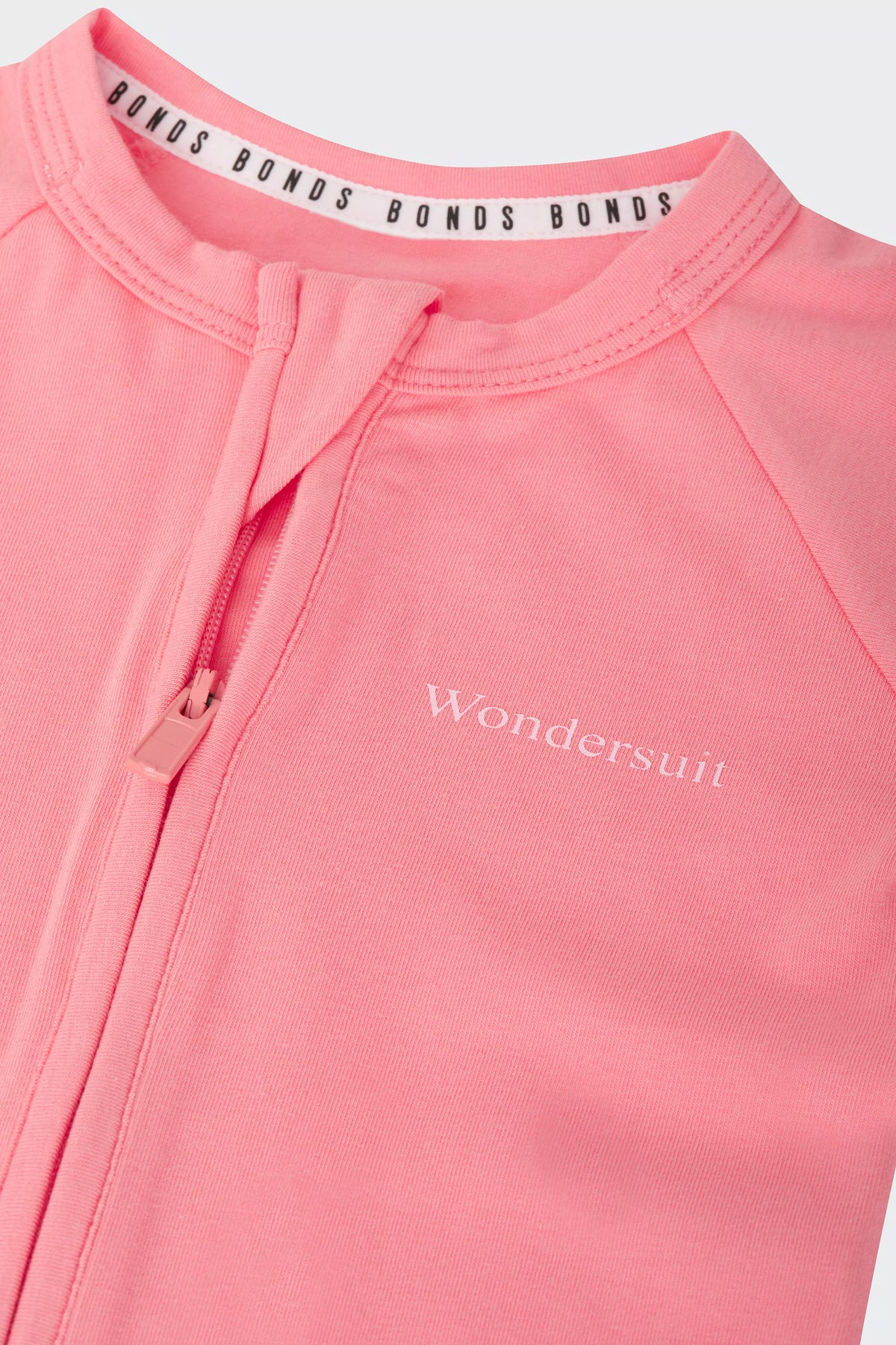 Bonds Everyday Value Zip Wondersuit baby sleepsuit in Island Punch salmon pink. Close up two-way zip.