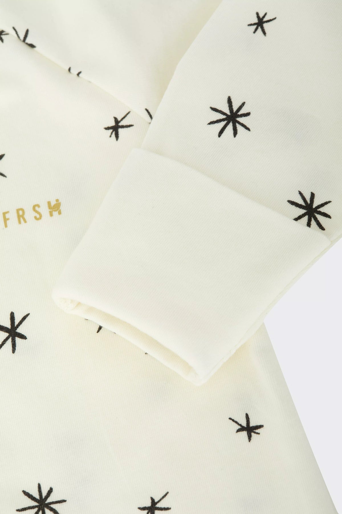 Bonds WonderFresh Short Leg Wondersuit baby onesie in Crayon Star cream print. Close up hand cuff.