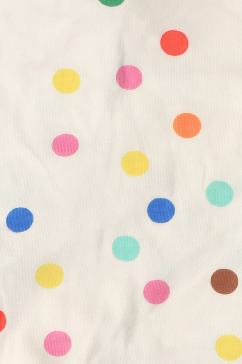 Bonds Zip Wondersuit baby sleepsuit in Confetti Love colourful polka dot and cream print. Close up.