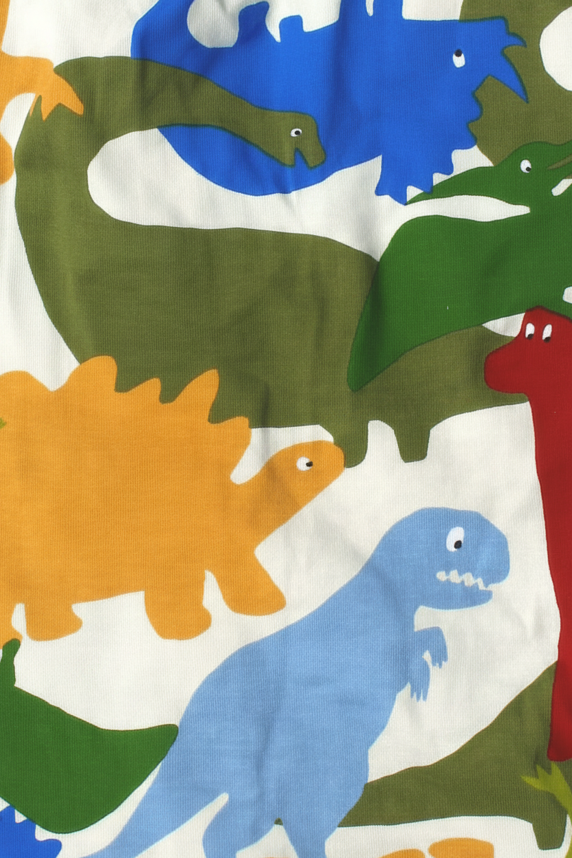Bonds Zip Wondersuit baby sleepsuit in Dino Dance Party white dinosaur print. Close up.