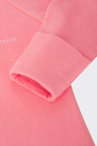 Bonds Everyday Value Zip Wondersuit baby sleepsuit in Island Punch salmon pink. Close up hand cuff.