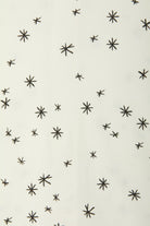 Bonds WonderFresh Short Leg Wondersuit baby onesie in Crayon Star cream print. Close up.