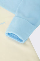 Bonds Everyday Value Zip Wondersuit baby sleepsuit in Levitating Airborne blue and cream. Close up hand cuff.