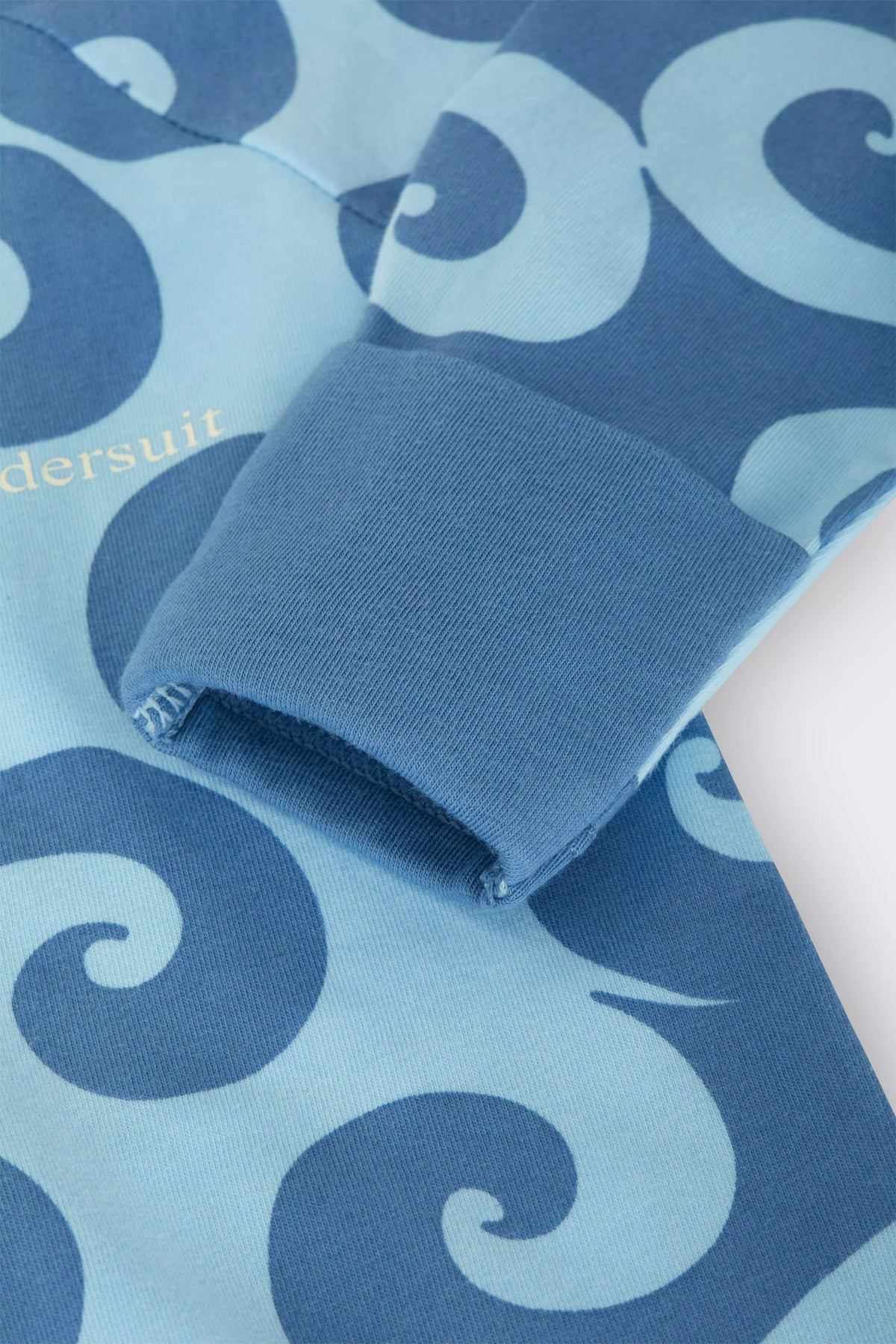 Bonds Zip Wondersuit baby sleepsuit in Wave Wonders blue wave swirl print. Close up hand cuff.