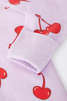 Bonds Zip Wondersuit baby sleepsuit in Cherry Picnic purple fruity print. Close up hand cuff.