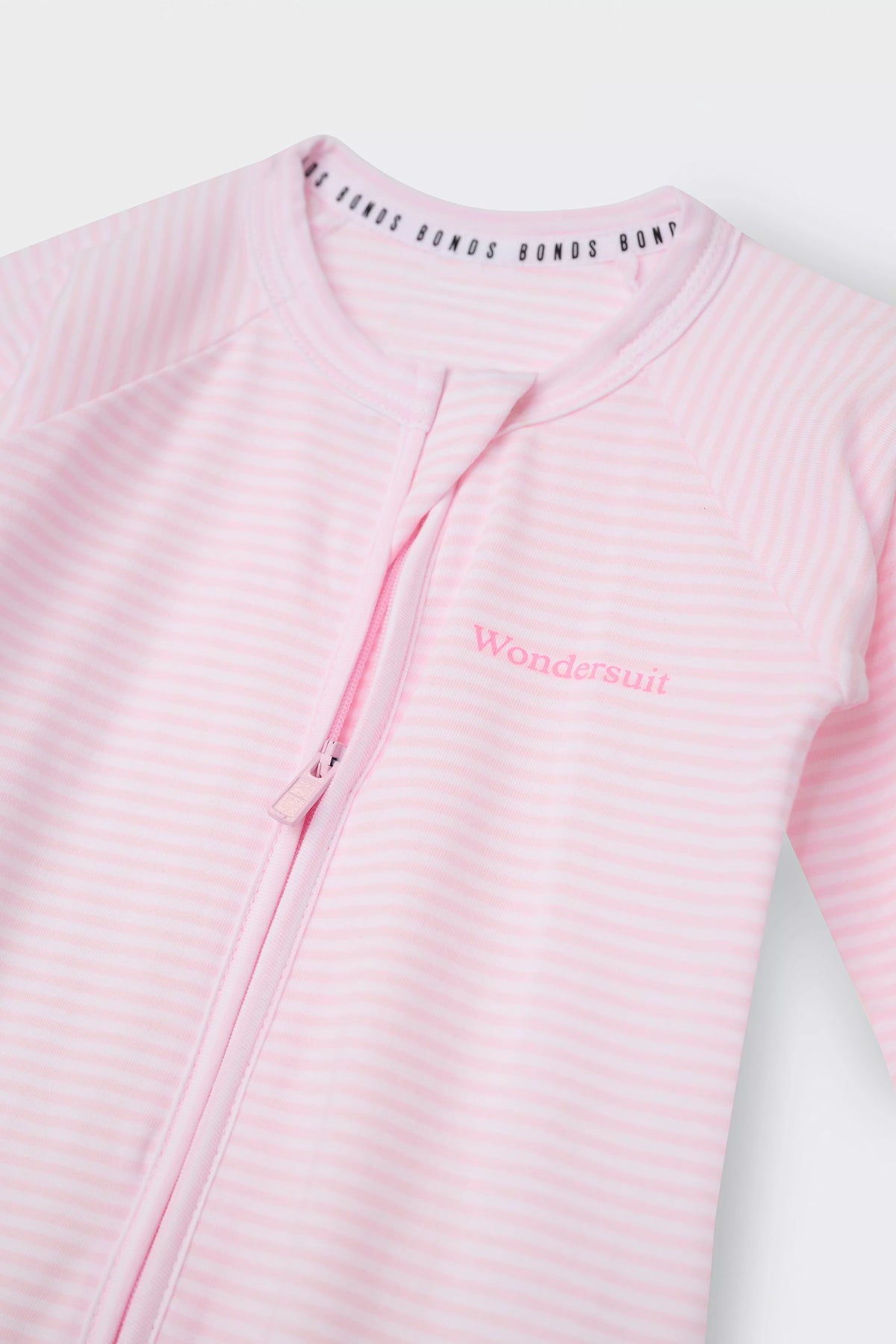 Bonds Zip Wondersuit baby sleepsuit in Ballet Pink and white stripe. Close up two-way zip.