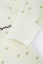 Bonds Poodlette Zip Wondersuit baby sleepsuit in Ditsy Dot Green polka dot print. Close up hand cuff.