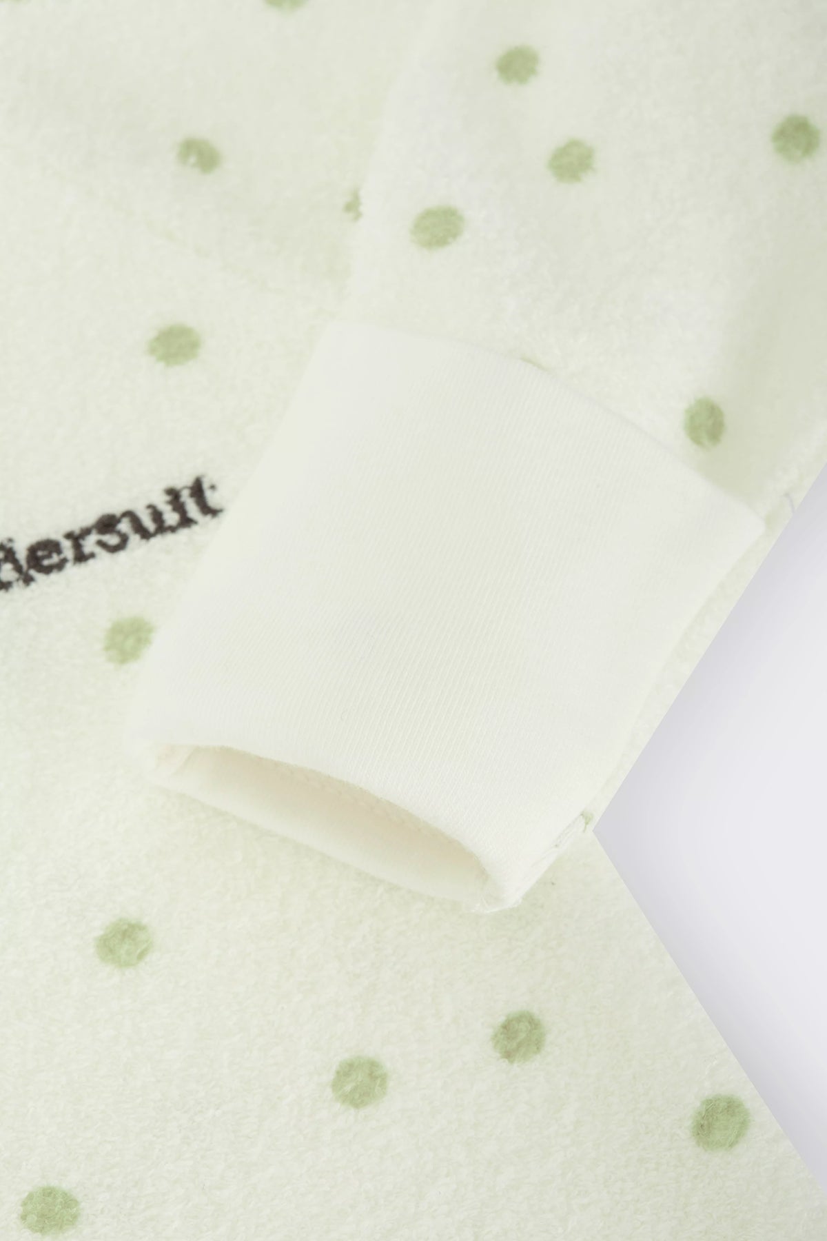 Bonds Poodlette Zip Wondersuit baby sleepsuit in Ditsy Dot Green polka dot print. Close up hand cuff.