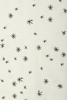 Bonds WonderFresh Short Leg Wondersuit baby onesie in Crayon Star cream print. Close up.
