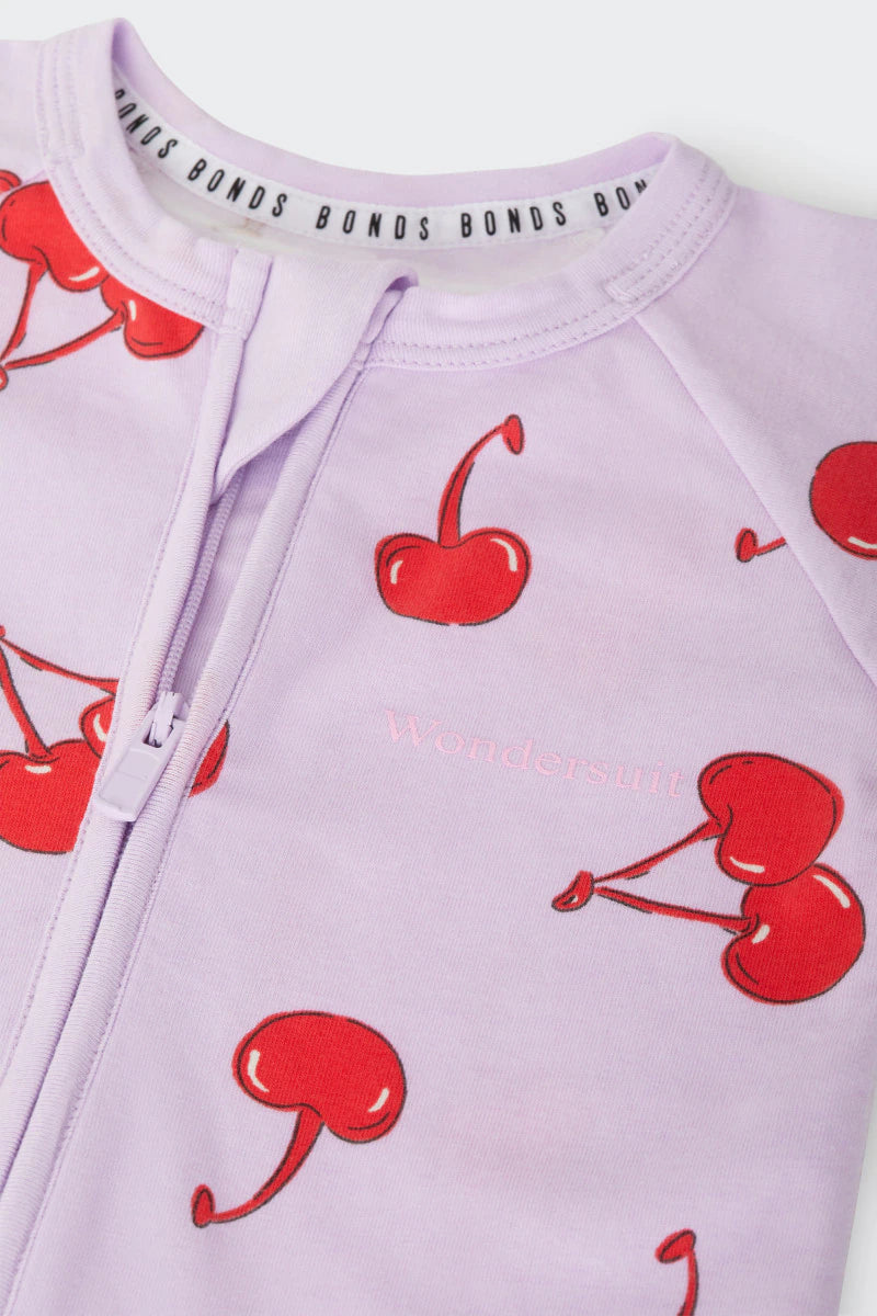 Bonds Zip Wondersuit baby sleepsuit in Cherry Picnic purple fruity print. Close up two-way zip.