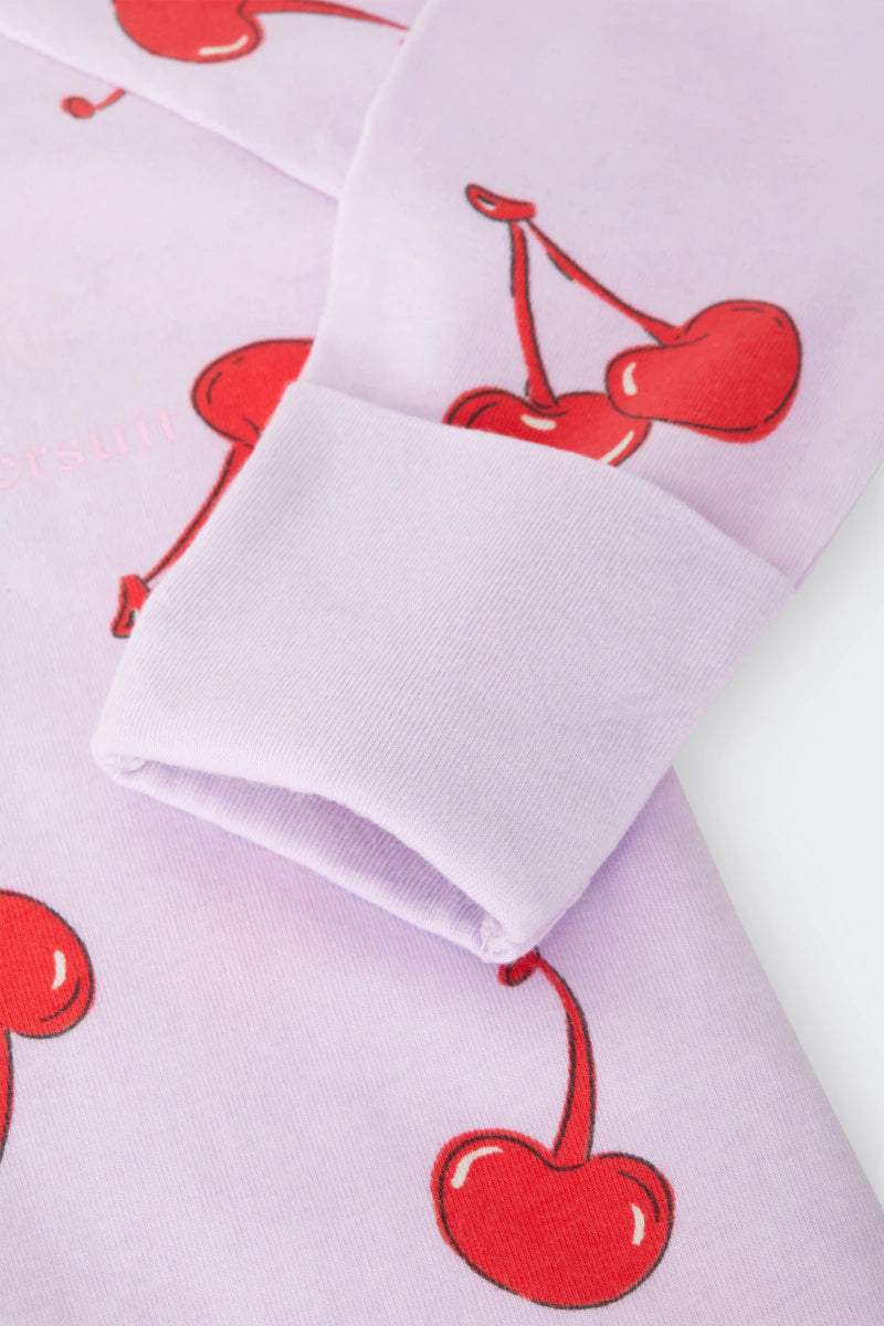 Bonds Zip Wondersuit baby sleepsuit in Cherry Picnic purple fruity print. Close up hand cuff.